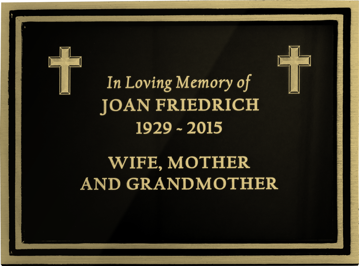 Traditional cast bronze plaque with "In Loving Memory of Joan Friedrich" text and two crosses.