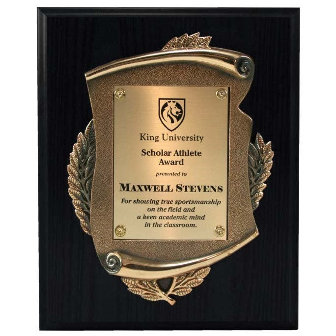 Gilded antique gold metal casting plaque on a dark wood base with personalized gold plate.
