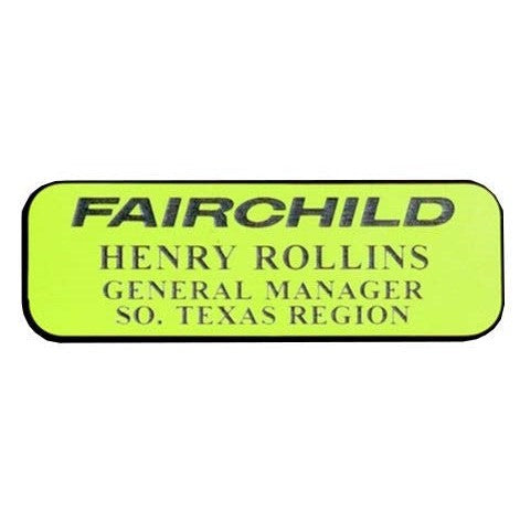 Lime green 1" x 3" engraved name badge with "FAIRCHILD" logo and "HENRY ROLLINS GENERAL MANAGER SO. TEXAS REGION" text.
