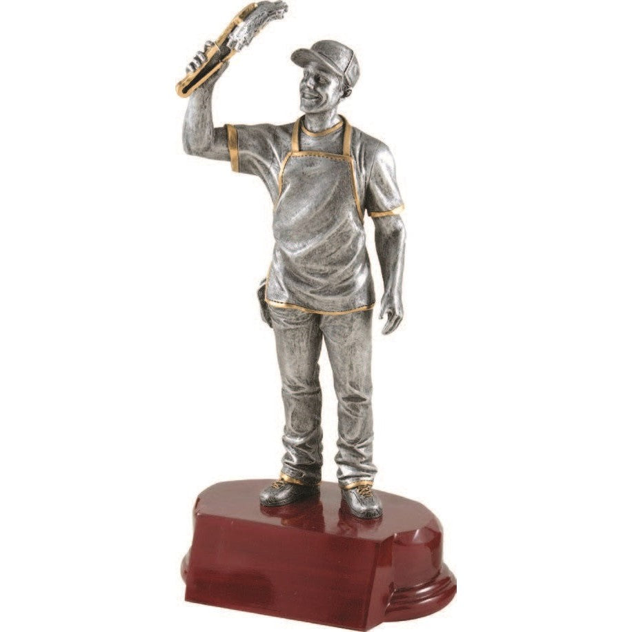 Silver Grill Master Award trophy, 9.25" tall, with gold trim, on a dark wood base. Features a man in an apron holding a spatula.