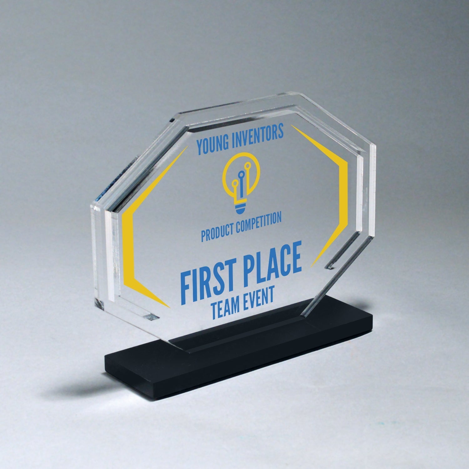 Clear acrylic octagon award with blue and yellow laser-etched design, mounted on a black base.