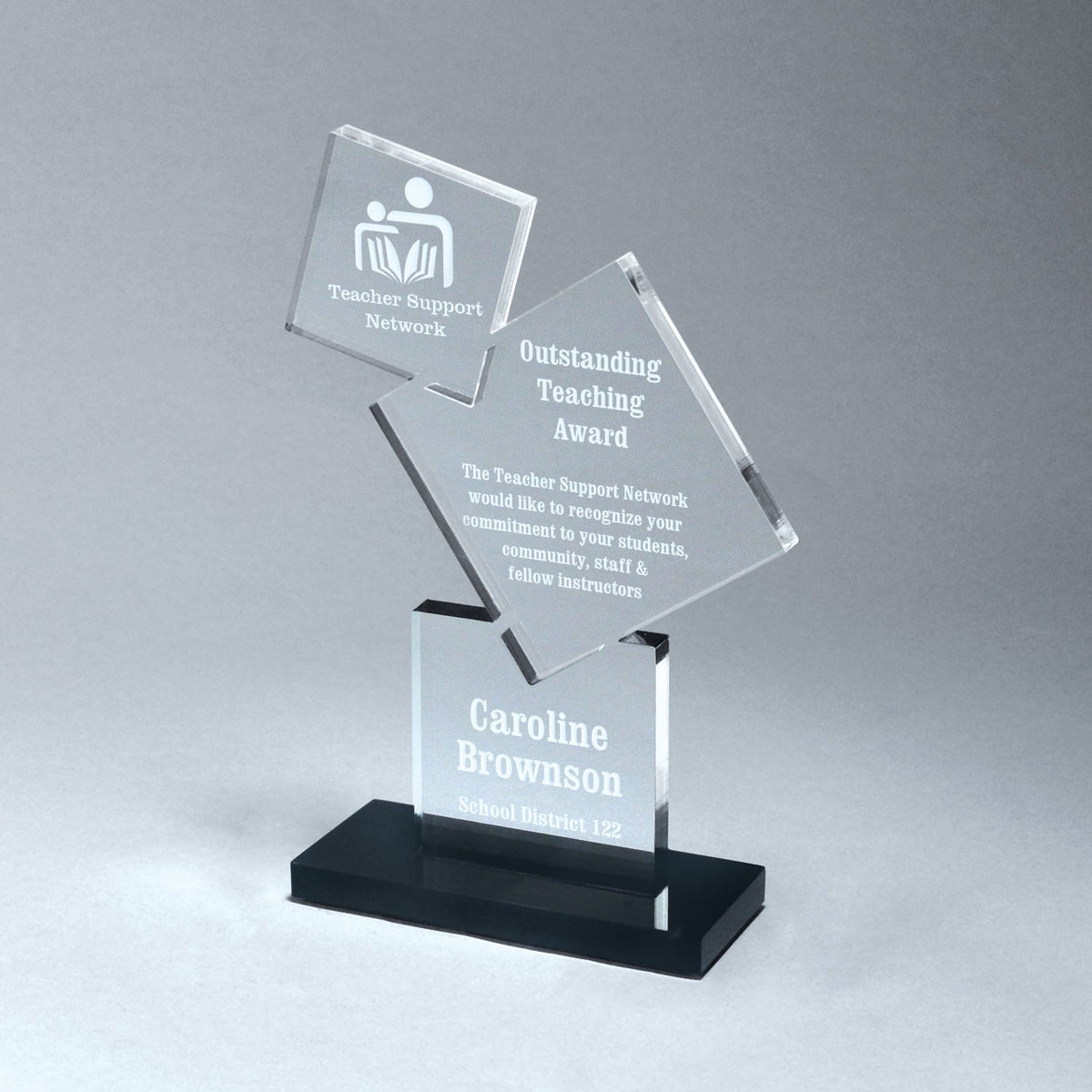 Clear stacked block award with laser-etched text on a black acrylic base.