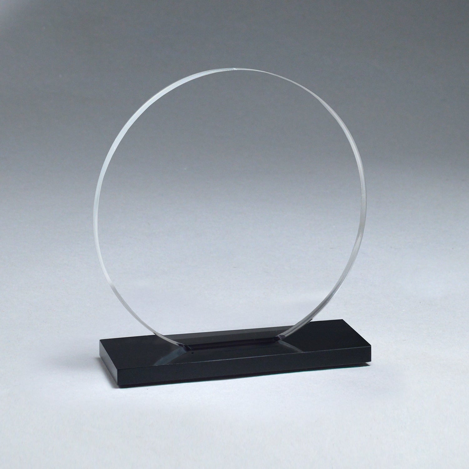 Clear acrylic Starfire Circle award with a sleek ebony acrylic base.