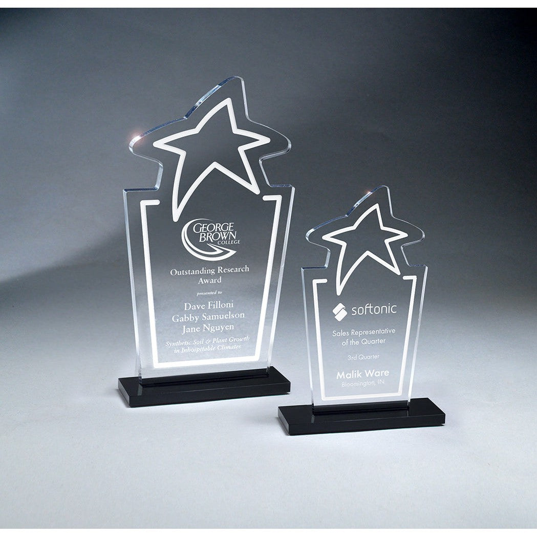 Two clear acrylic star-shaped trophies with black bases, one large and one small, both engraved.