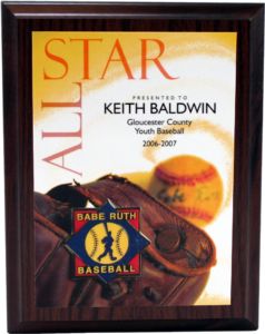 Dark wood plaque with "ALL STAR" graphic, baseball glove, ball, and "Babe Ruth Baseball" logo.