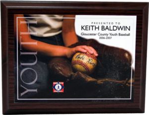 Dark wood plaque with full-color graphic of a child's hand holding a Babe Ruth baseball, personalized for Keith Baldwin.