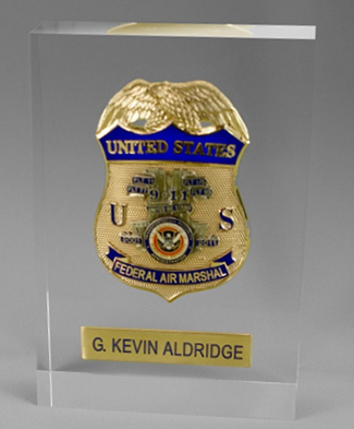 Clear acrylic award with embedded gold and blue Federal Air Marshal badge and personalized nameplate.