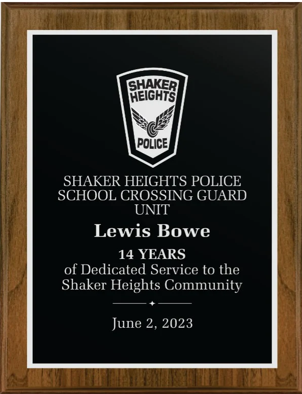 Executive walnut plaque with a black lasered plate, white text, and the Shaker Heights Police logo.