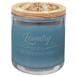 14 oz. blue scented candle in a clear glass holder with a light wood lid featuring an engraved design.
