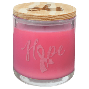 14 oz. pink scented candle in a clear glass holder with "Hope" and a ribbon etched, topped with a wood lid.