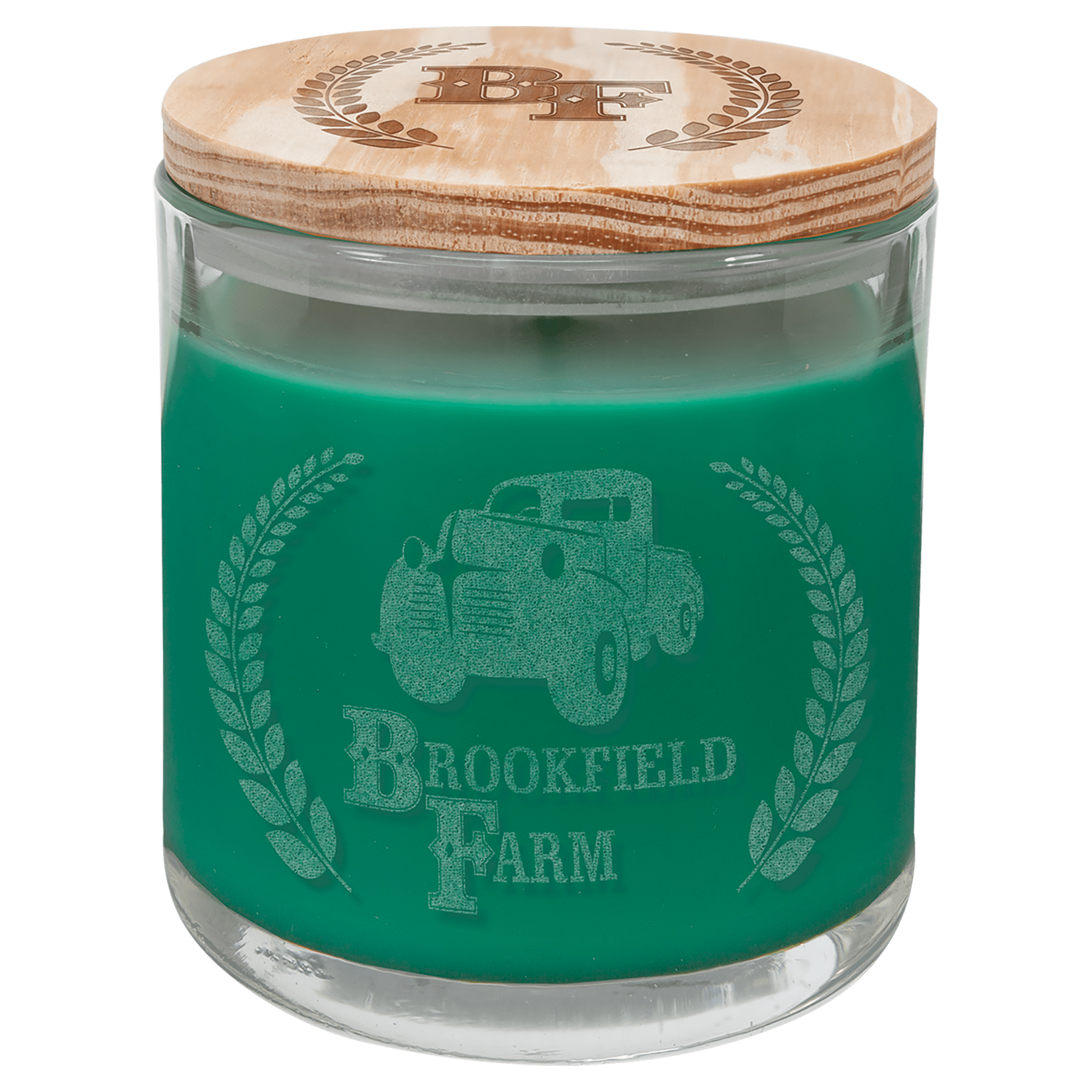14 oz. green scented candle in a clear glass holder with a wood lid, custom engraved with "Brookfield Farm" logo.