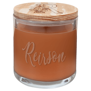 14 oz. scented candle in a clear glass holder with "Reirson" engraved and a wood lid with an "R" design.
