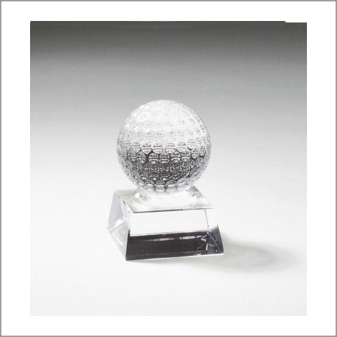 Clear crystal golf ball award with dimpled texture on a square clear base.