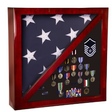Rosewood piano finish flag and memorabilia display case with a folded American flag and military medals.