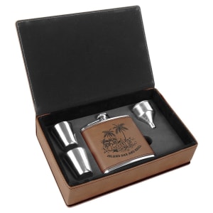 Brown leatherette flask gift set with laser-engraved island design, two shot glasses, and a funnel.