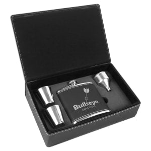 Black laserable leatherette flask gift set with flask, two shot glasses, and funnel in an open box.