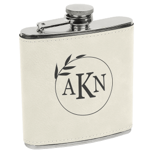 6 oz. stainless steel flask with light beige laserable leatherette wrap and a personalized "AKN" monogram.