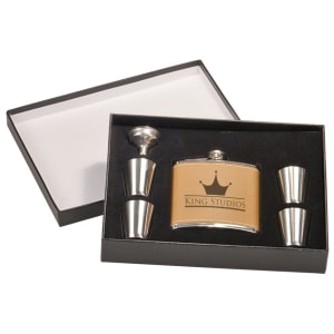 Tan leatherette 6 oz flask with "KING STUDIOS" logo, funnel, and four shot glasses in a black presentation box.