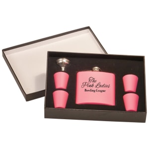 Black presentation box open, revealing a pink flask engraved "The Pink Ladies Bowling League," four pink shot glasses, and a funnel.