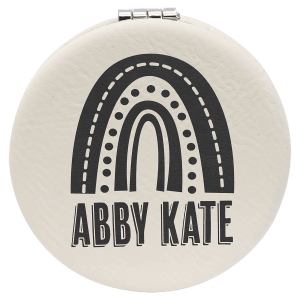 2.5" round cream laserable leatherette compact mirror with a black rainbow and "ABBY KATE" engraving.