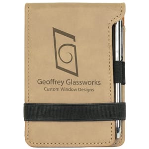 Tan laserable leatherette mini notepad with custom "Geoffrey Glassworks" logo and a silver pen.