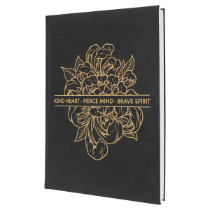 Black 7" x 9 3/4" laserable leatherette journal with gold floral design and "KIND HEART - FIERCE MIND - BRAVE SPIRIT" text.