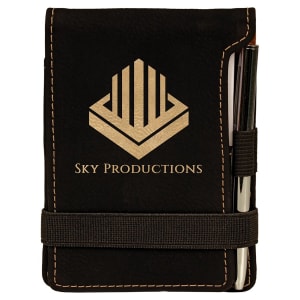 Black leatherette mini notepad with a gold "SKY PRODUCTIONS" logo, pen, and elastic closure.