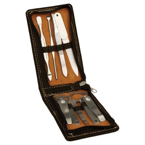 Open black leatherette manicure set with 7 silver tools on a brown interior, zipper closure.