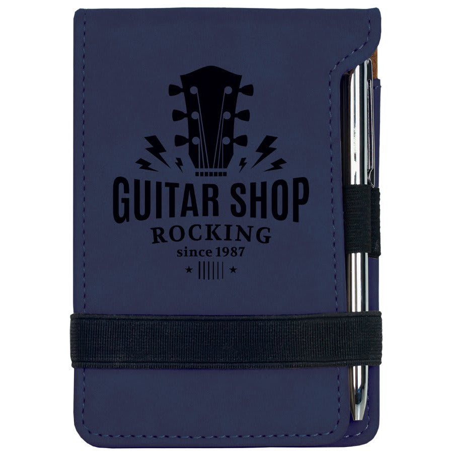 Navy blue laserable leatherette mini notepad with "Guitar Shop" logo and pen.