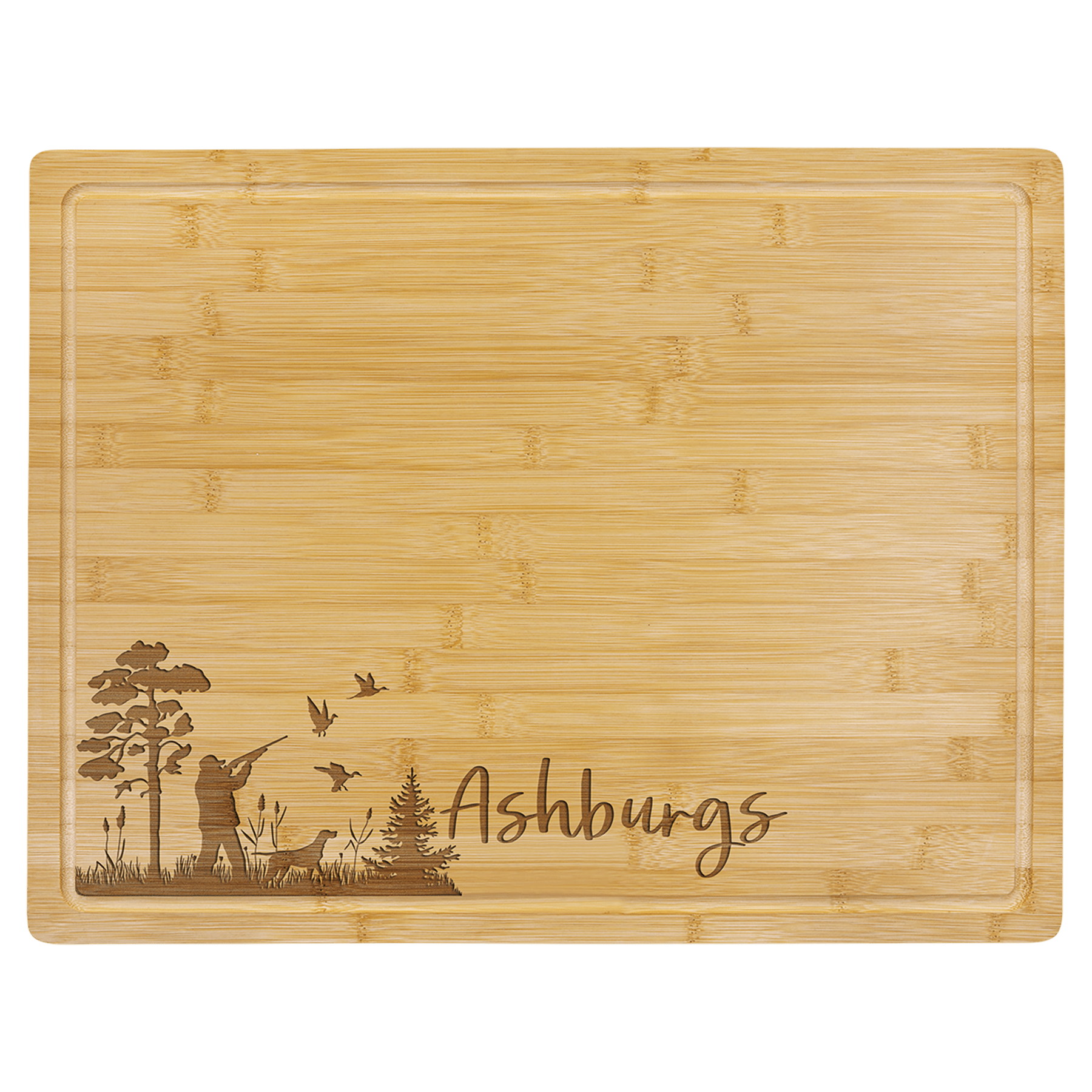 Light bamboo cutting board with drip ring, engraved with a hunter, dog, ducks, trees, and "Ashburgs.