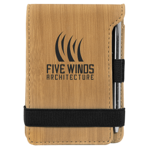Tan laserable leatherette mini notepad with "Five Winds Architecture" logo, pen, and black elastic band.