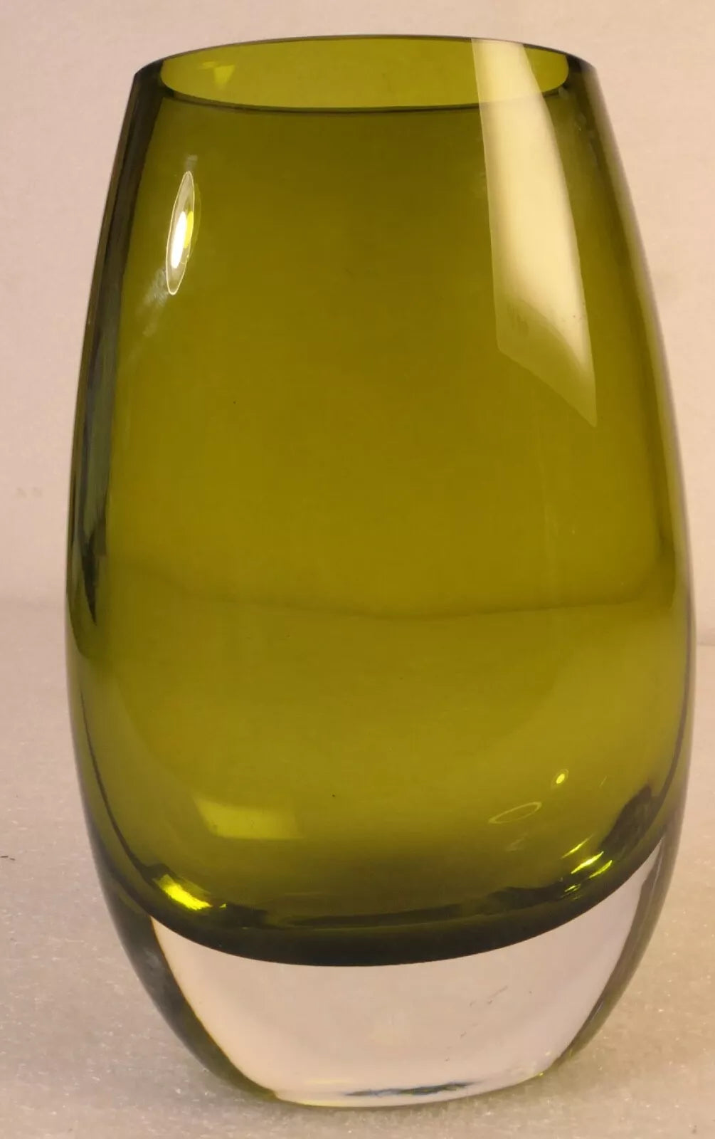 8" tall, beautiful green glass vase with a thick, clear base.