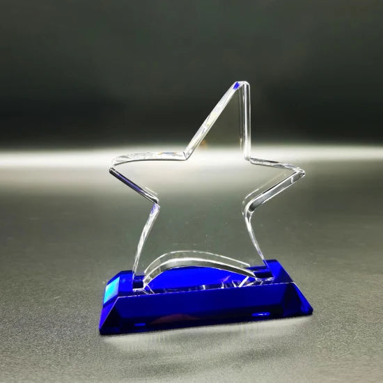 Clear glass star award on a rectangular blue stand, 6" tall.