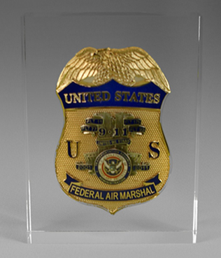 Clear acrylic custom embedment featuring a gold and blue Federal Air Marshal badge.