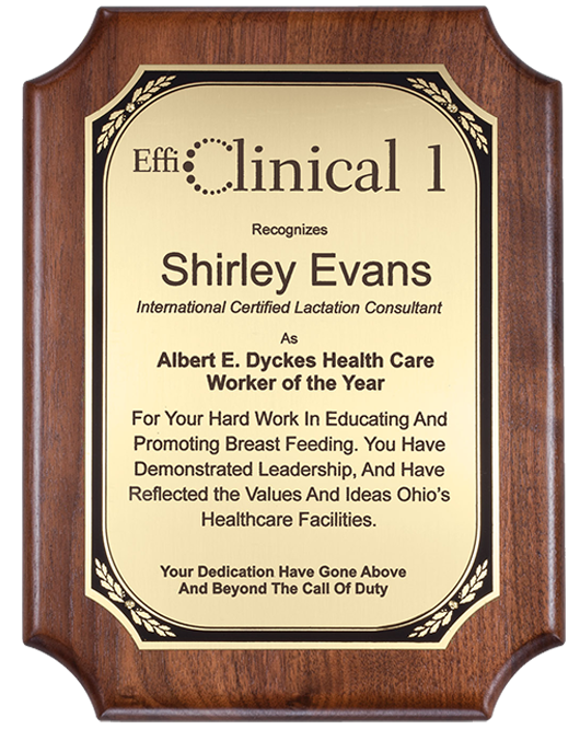 Walnut plaque with notched corners and a gold plate, recognizing Shirley Evans as Worker of the Year.