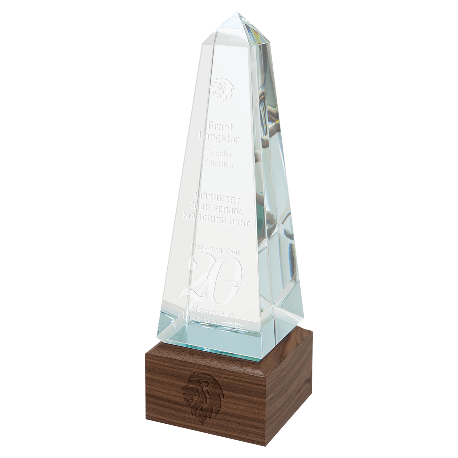 Clear glass obelisk award with engraved text, resting on a square dark walnut base.