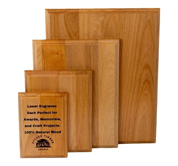 Four light wood Red Alder plaques in varying sizes, with one small plaque laser engraved with text and a logo.
