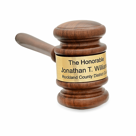 Solid walnut gavel with a dark brown finish and an engraved gold band.