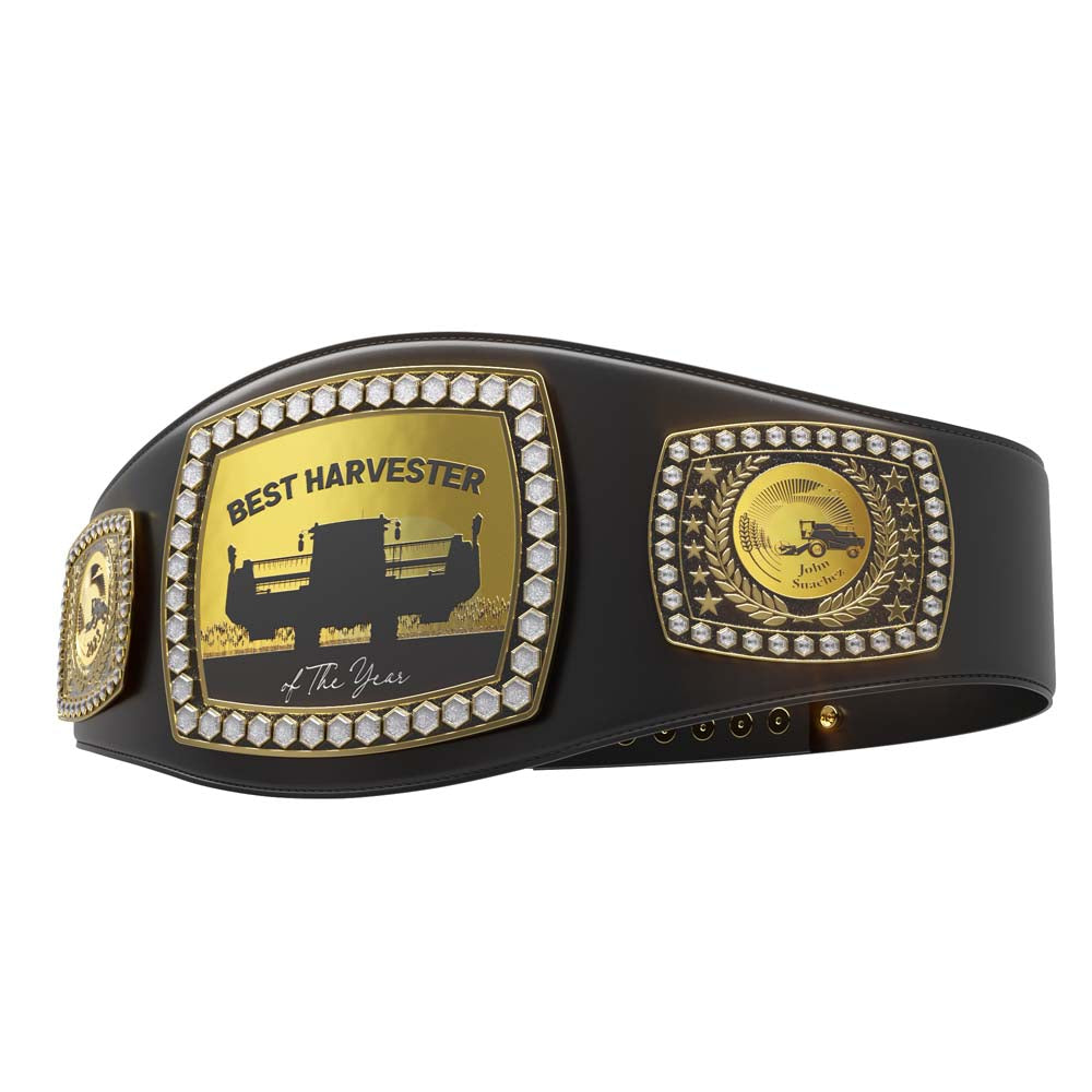 Black leather award belt with gold plates, "Best Harvester of The Year" text, combine silhouette, and diamond-like stones.