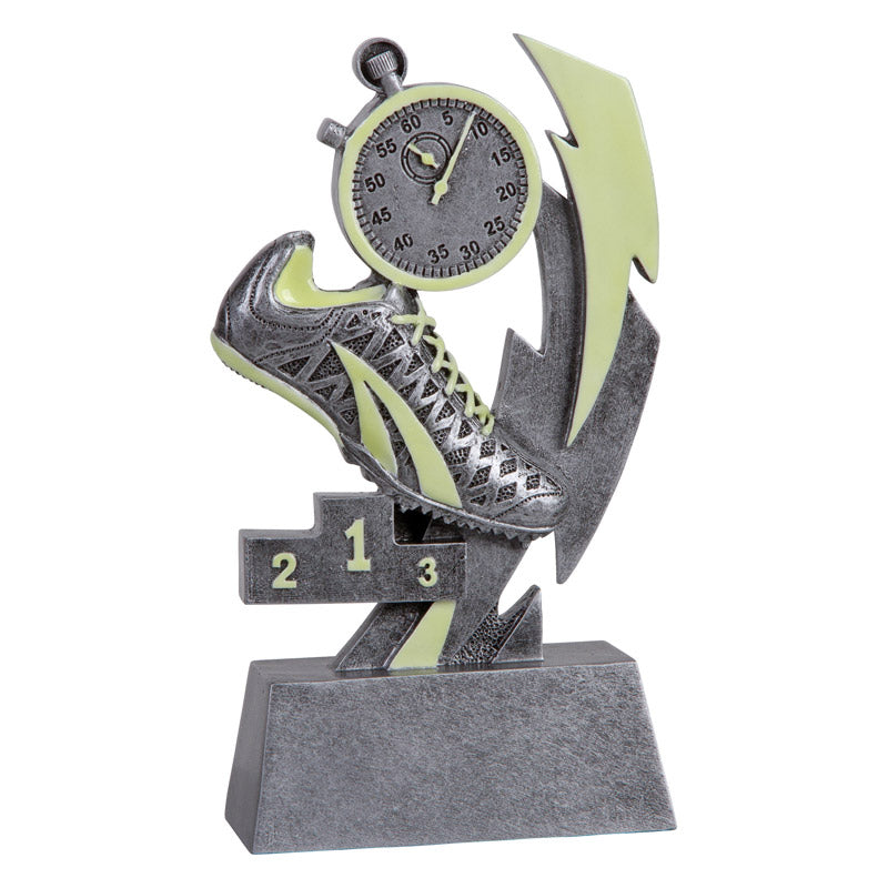 Glow-in-the-dark track resin trophy with a silver running shoe, stopwatch, lightning bolt, and 1-2-3 podium.