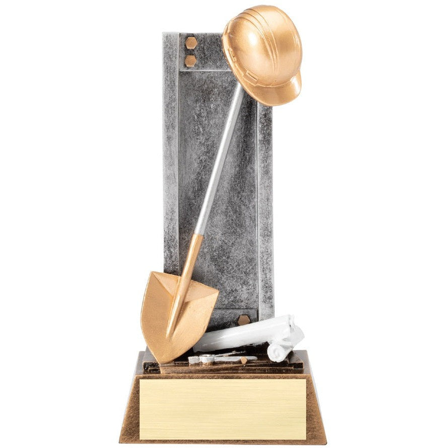 Bronze and silver groundbreaking trophy with a hard hat, shovel, and white pipe on a wood base with a gold plate.