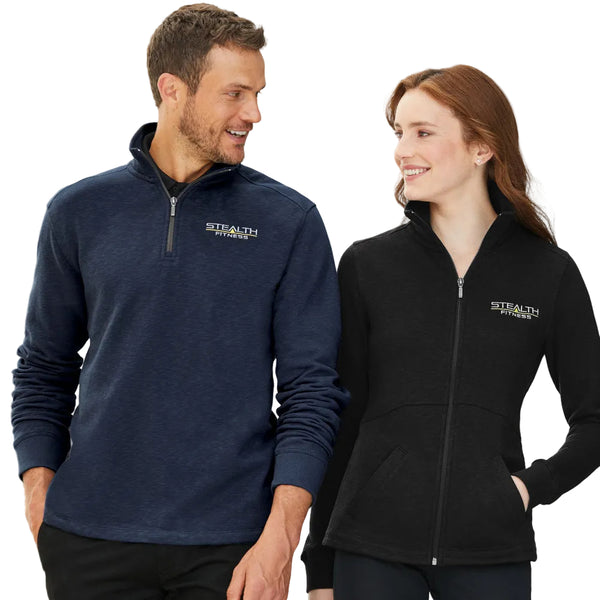 Two people wearing Stealth Fitness jackets standing indoors.