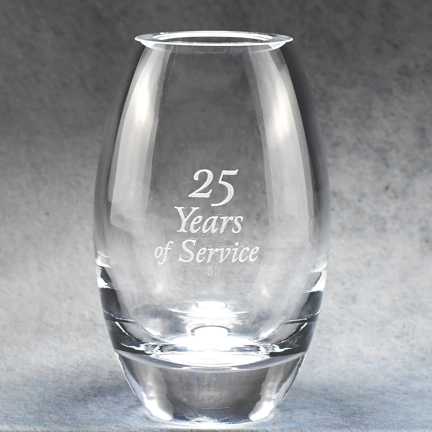 Clear lead crystal barrel vase, 9" tall, with "25 Years of Service" engraved on the front.