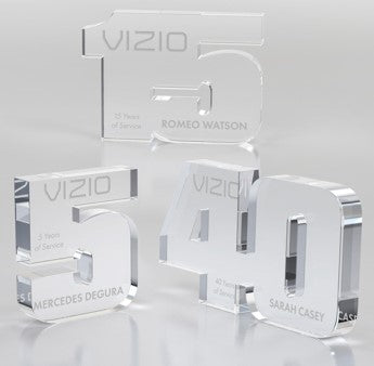 Clear acrylic awards shaped as numbers 5, 15, and 40, engraved with VIZIO, years of service, and names.